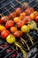 Grilling tomato skewers, skewers of colorful cherry tomatoes studded on rosemary sprigs with the addition of aromatic spices and s