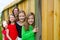 Grils group in a row smiling in a wooden fence