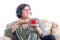 Grimacing woman gesturing to cup of coffee