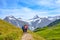 Grindelwald, Switzerland - August 16, 2019: Summer Alpine landscape. Female hikers and Swiss Alps in the background. Photographed