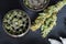 Grinder for chopping weed cannabis and a flower of marijuana on a black background surrounded by joint