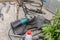 Grinder, welding, pipe wrench and other hand tools on the concrete floor next to the workshop