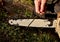 Grinding the chainsaw chain with a round file at the right angle of the cutting and cutting teeth of the blade. logging in leather