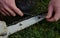 Grinding the chainsaw chain with a round file at the right angle of the cutting and cutting teeth of the blade. logging in leather