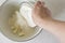 Grinding wheat flour and butter in a pie pan