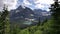 grinnell lake pine framed by pine trees at glacier national park