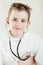 Grinning child checking his pulse with stethoscope