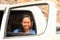 Grinning girl in car window