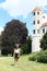 Grinning girl in front of tower of castle in Telc