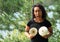 Grinning girl holding parasol mushrooms in front of chest