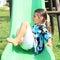 Grinning girl on a slide