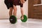 Gripping a barbell young man standing gripped a black and green weight set, equipment for weight training concept