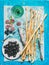 Grissini bread sticks, sausage, olives and white wine, blue background