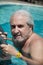grizzled man in cuba pool. summer vacation in cuba. man swim in cuba resort