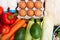 Groceries on a wooden background. Vegetables, eggs and other foo