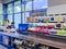 Grocery checkout counter with a moving belt and small items at eye level in Lidl supermarket, Riga.