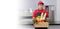 Grocery delivery courier man in red uniform and apron with grocery box with food, fresh fruit and vegetable. Deliver man handling