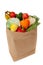 Grocery sack full of vegetables on white