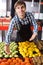 Grocery worker selling seasonal fruits