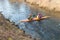 GRODNO, BELARUS - APRIL, 2019: kayak freestyle competition on fast cold water river strenuously rowing, spirit of victory