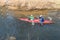 GRODNO, BELARUS - APRIL, 2019: kayak freestyle competition on fast cold water river strenuously rowing, spirit of victory