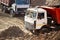 GRODNO, BELARUS - APRIL 2020: Two heavy laden multi-ton trucks MAZ exporting minerals from open-pit mine. Concept of