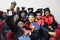 GRODNO, BELARUS - JUNE, 2018: Foreign african medical students in square academic graduation caps and black raincoats during