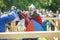 GRODNO, BELARUS - JUNE 2019: medieval jousting knight fight, in armor, helmets, chain mail with axes and swords on lists. historic