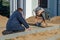 Grodno, Belarus, October 21, 2018: a group of builders engaged in the repair of a Catholic church. Laying a new sidewalk. Chief