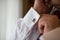 The Groom adjusts black cufflinks on the white shirt. The businessman adjusts his sleeve on the white shirt.