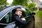 Groom arrives by car at village church on his wedding day