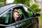 Groom arrives by car at village church on his wedding day