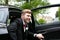 Groom arrives by car at village church on his wedding day