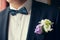 Groom in black suit with flower buttonhole