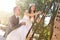 Groom and bride climbing a rusty ladder