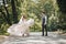 Groom and bride in the garden. Spring wedding in the park. Happy wedding couple running in the park. Stylish and beautiful.