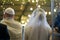 Groom with the bride on a hupa of the Jewish wedding. Rear view.