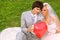 Groom and bride keep red balloon heart