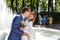 Groom and bride kissing near a fountain