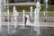 Groom and bride next to a fountain and water jets