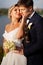 groom and bride in traditional wedding clothes cuddling in the park on the shore