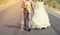 Groom and bride walking in the road go to marry