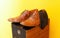 Groom brown wedding shoes on speaker. Yellow background.
