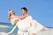 Groom Carrying Bride At Beautiful Beach Wedding