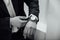 Groom clasping stylish watch band on his wrist