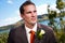 Groom and corsage with blue water behind