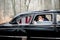 Groom in dark blue jacket leans to bride for a kiss