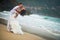 Groom embraces the bride at the sea. couple in love on a deserted beach