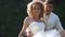 groom embraces bride sitting in longtail boat