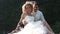 Groom Embraces Bride Sitting in Longtail Boat